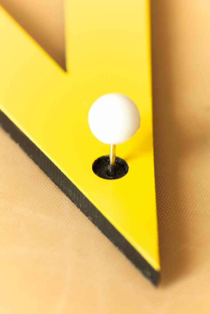 Marked holes are used to fix the drawing tools with pins