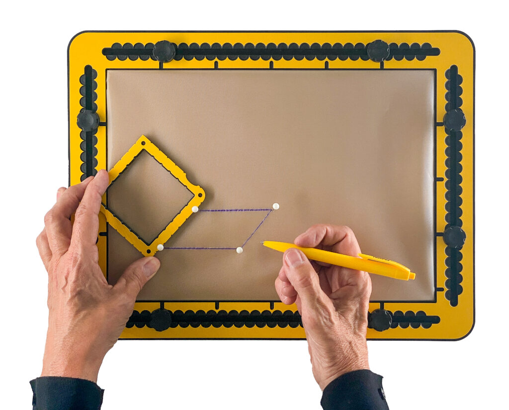 Four pushpins mark the corners of a parallelogram; the square tool is used to draw the fourth side of the shape.